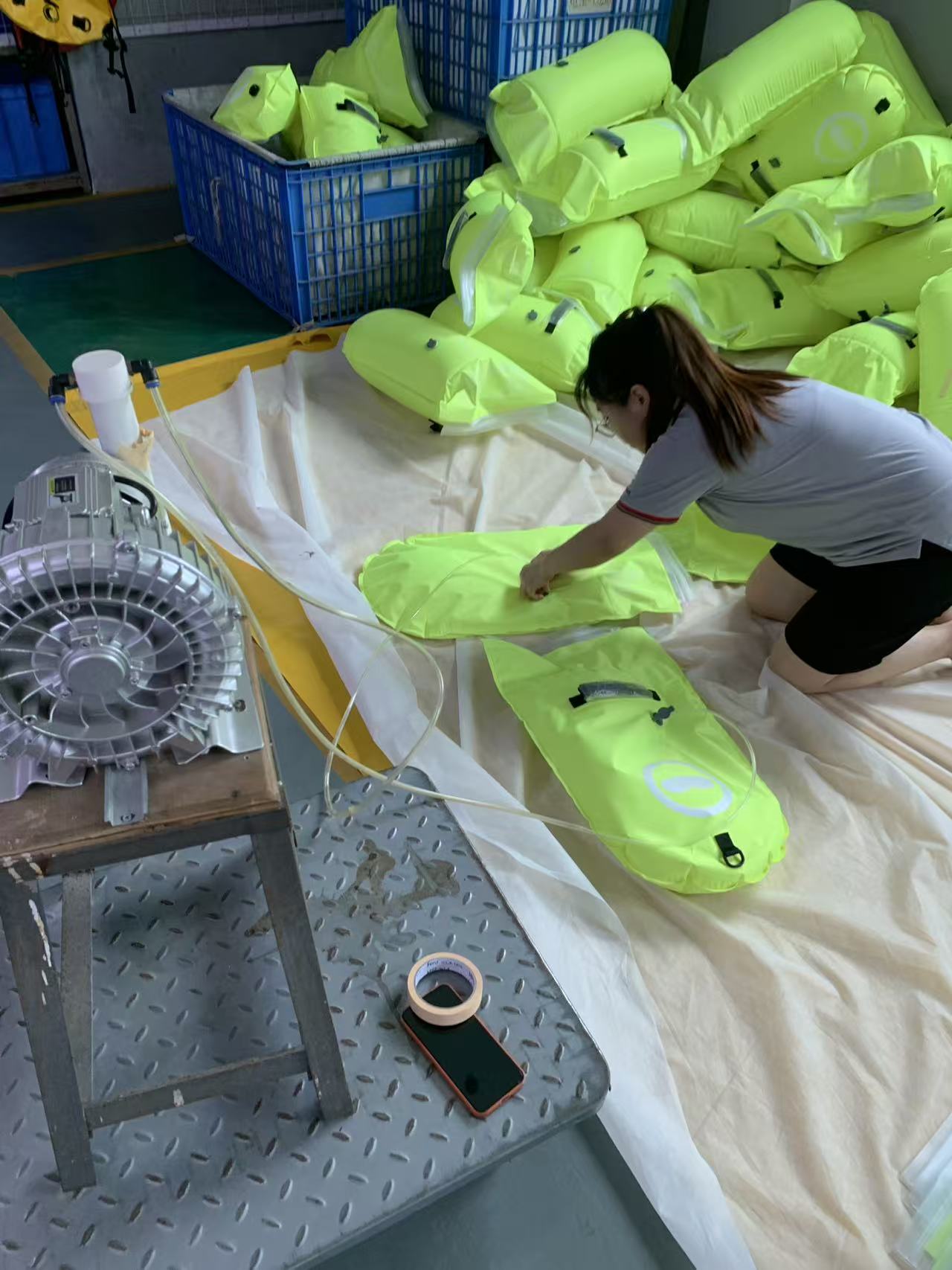 Close view of a swim buoy being filled and hand-checked